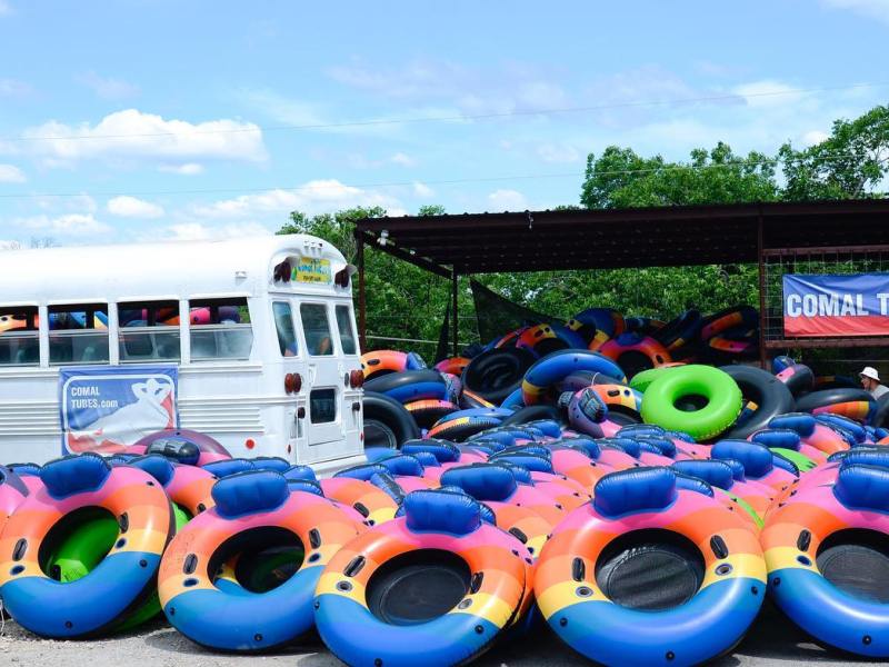a group of people on a motorcycle in a parking lot