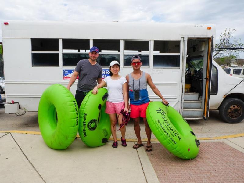 a group of people standing in front of a green truck