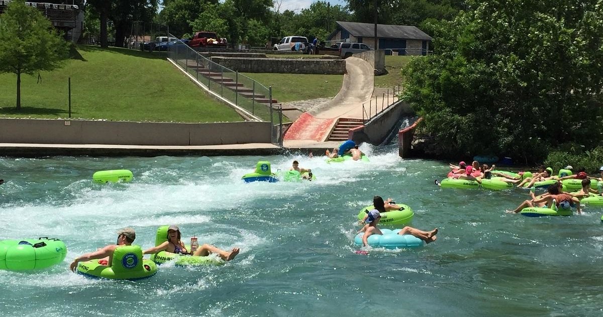 Comal River Tubing Image 1 a group of people swimming in the water